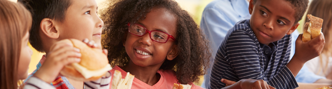 Photo of children eating lunch at school together